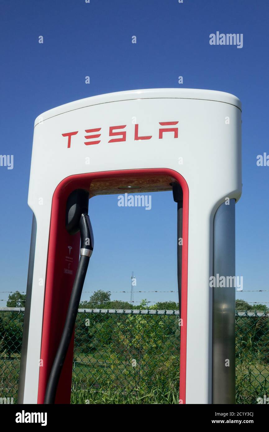 Close Up Of A Tesla Electric Car Charging Station Supercharging Network Stock Photo
