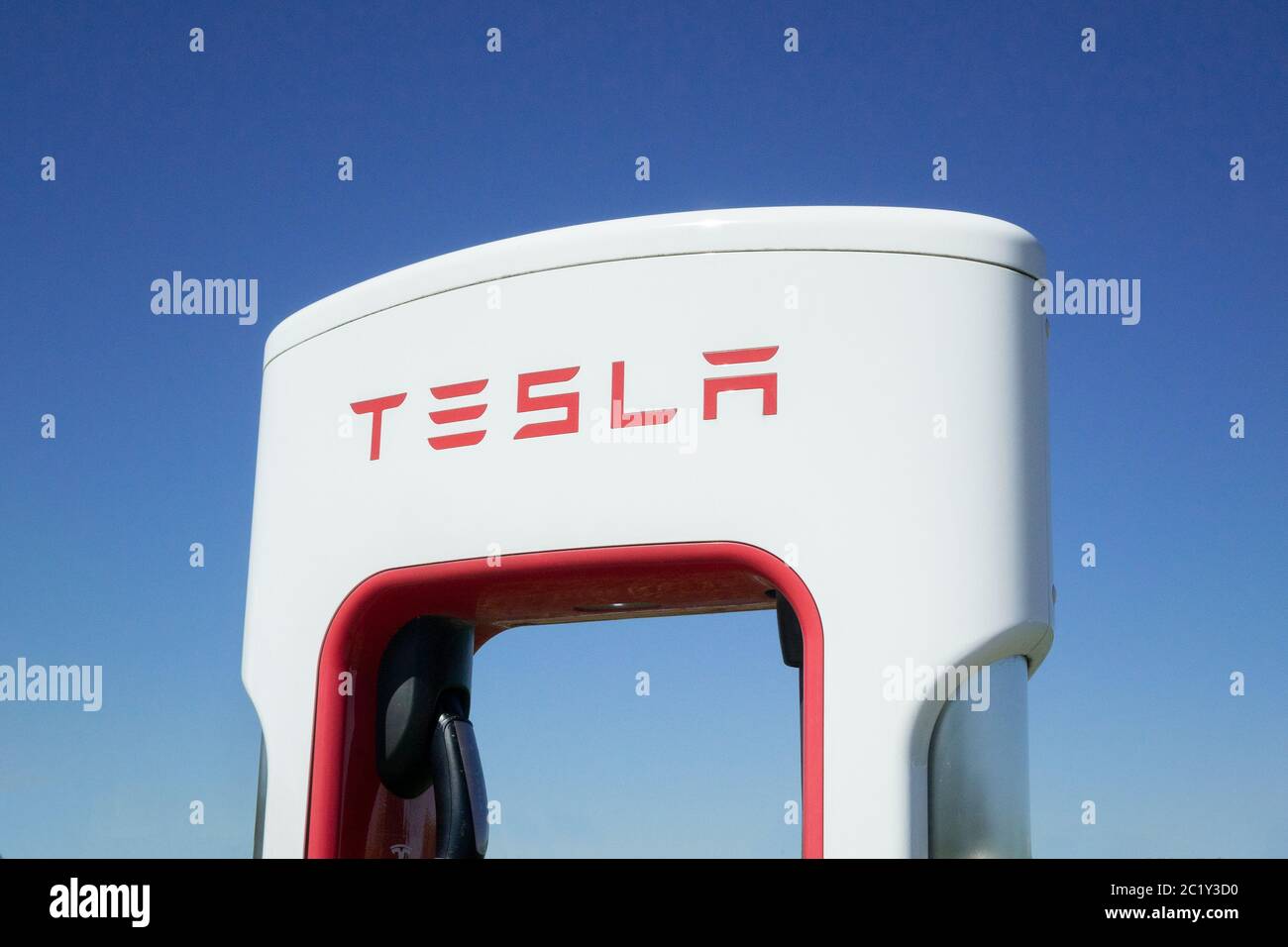Close Up Of A Tesla Electric Car Charging Station Charging Network Stock Photo