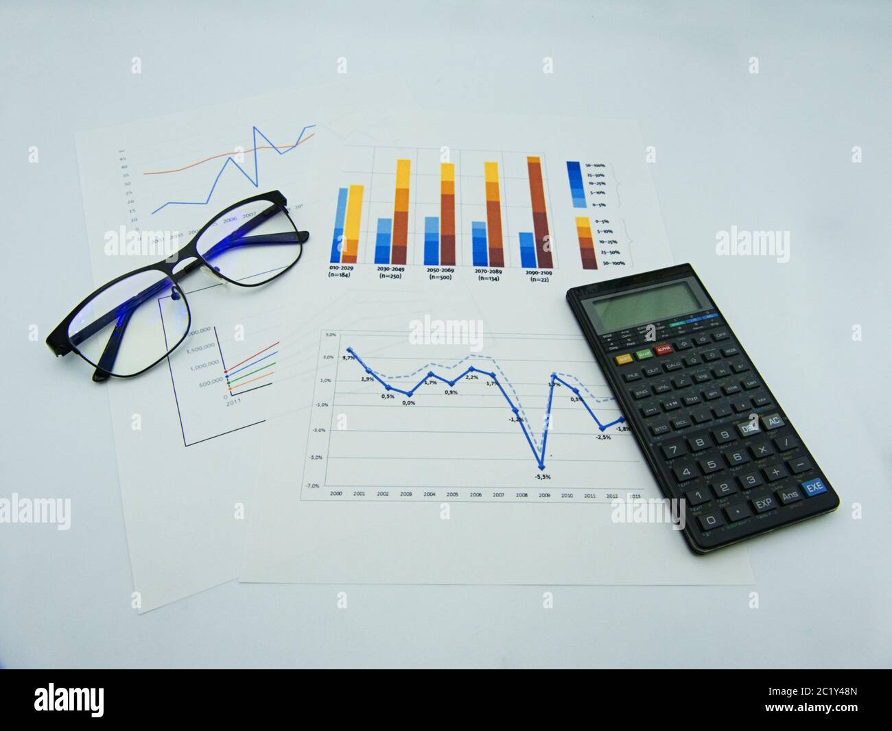 Data graphs and diagrams, glasses and calculator, white background