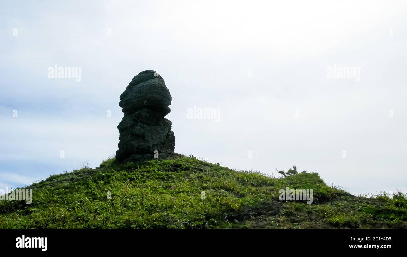 Funny rock sculpture at the top of the hill above the Tikhaya bay Yuzhno-Sakhalinsk, Sakhalin, Russia Stock Photo