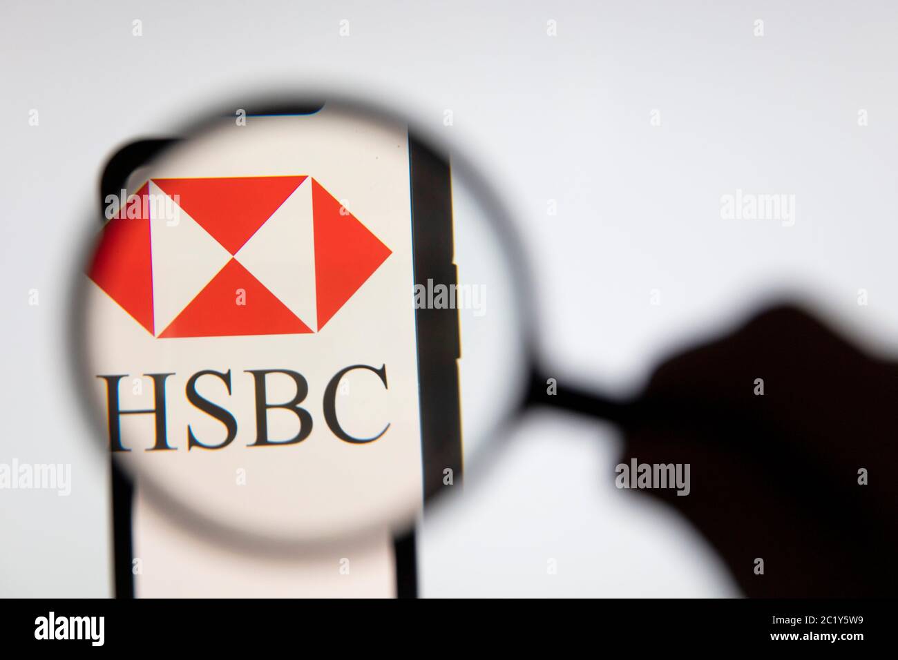 LONDON, UK - June 2020: HSBC bank logo on a smart under magnifying glass Stock Photo