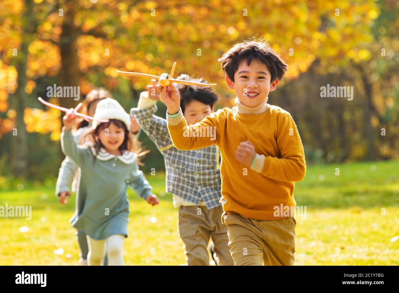 With a model plane happy children playing in the park Stock Photo - Alamy