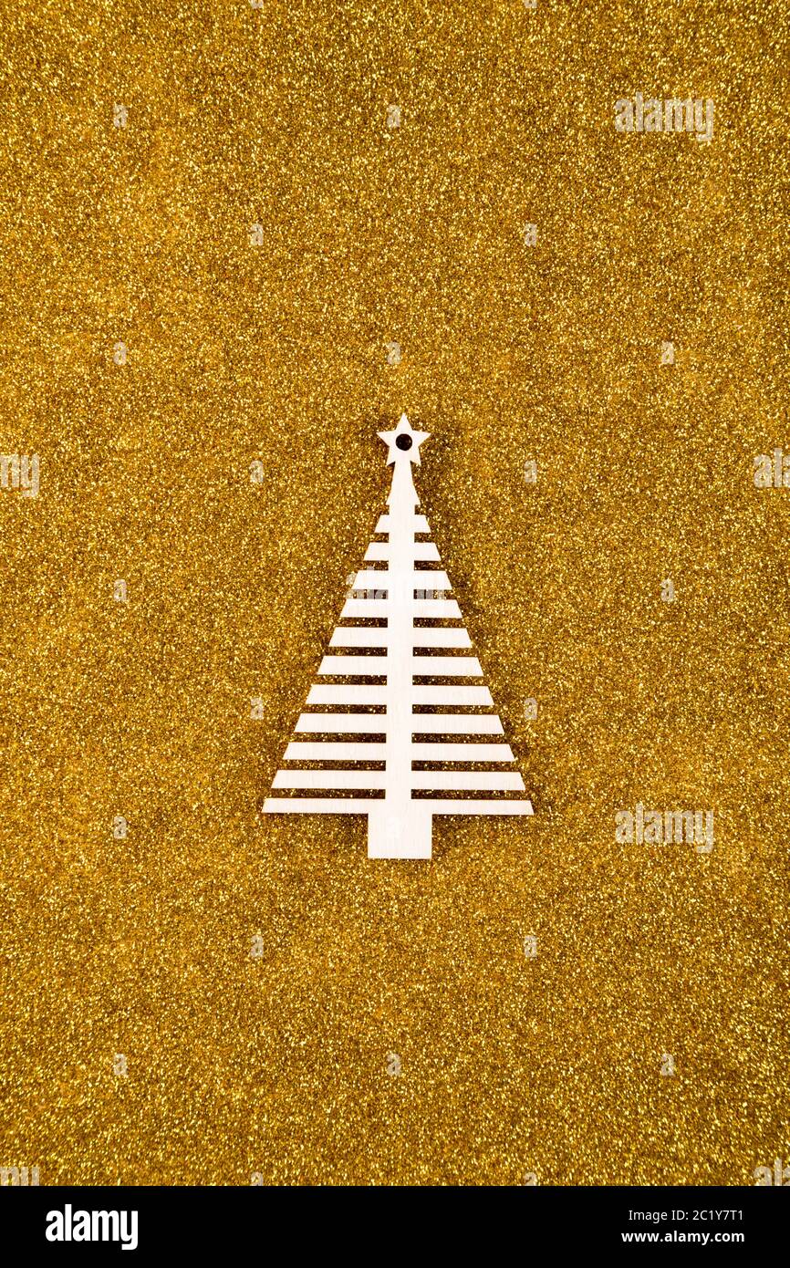 Wooden Christmas tree shape on golden glitter background Stock Photo ...