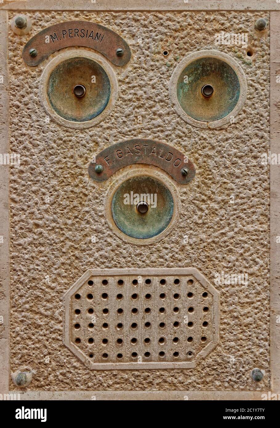 Bell push and intercom facia with face-like appearance from an apartment block in Venice, Italy. Stock Photo