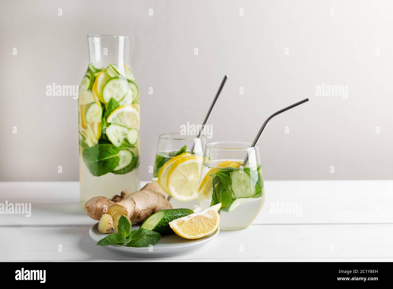 Sassy water slimming or infused water with lemon,mint, cucumber and ginger in glasses with metal tubes. Zero waste concept. Stock Photo