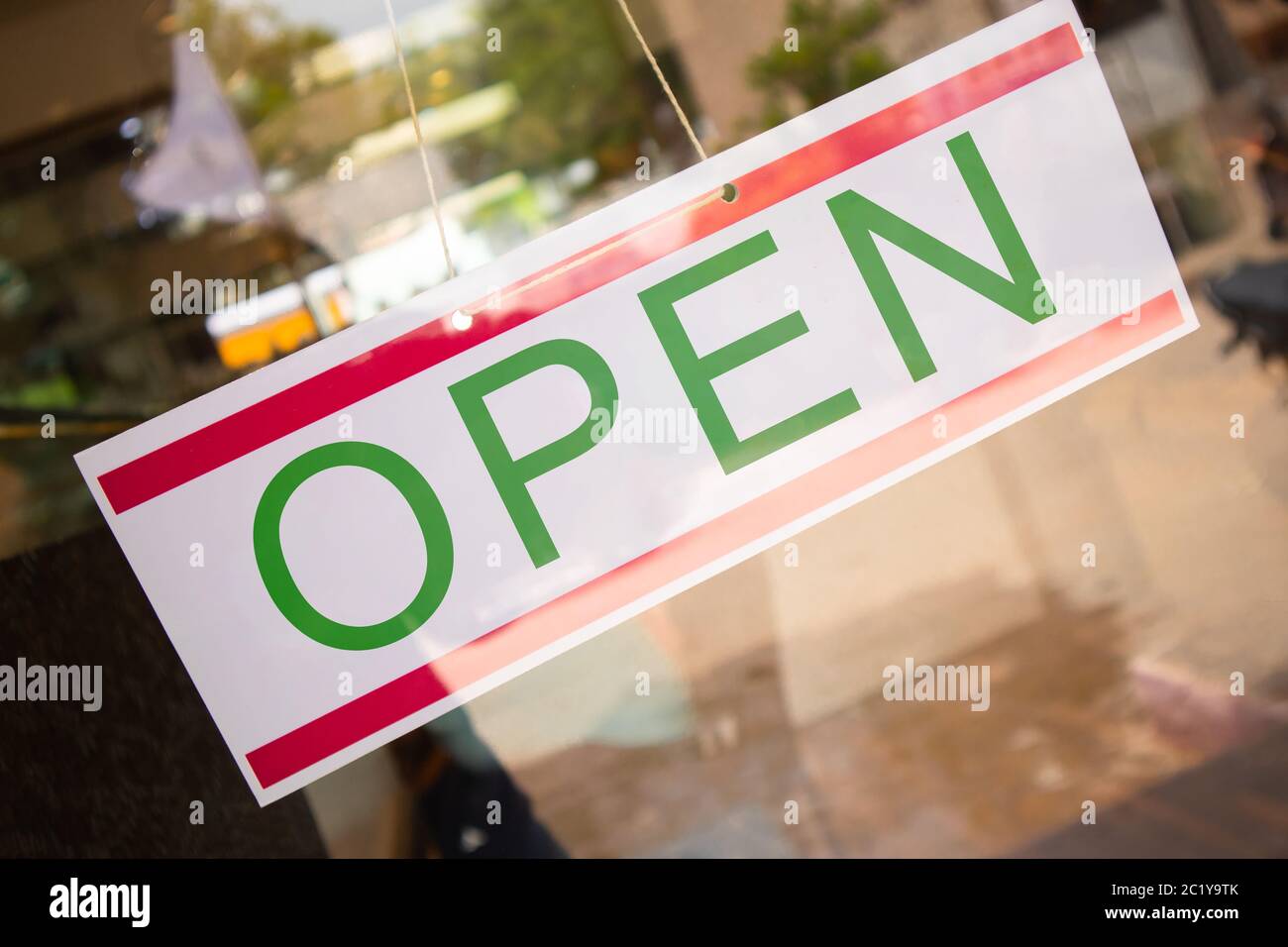 Open Signage board in front of Businesses or store door after covid-19 or coronavirus outbreak - Concept of back to business after lockdown. Stock Photo