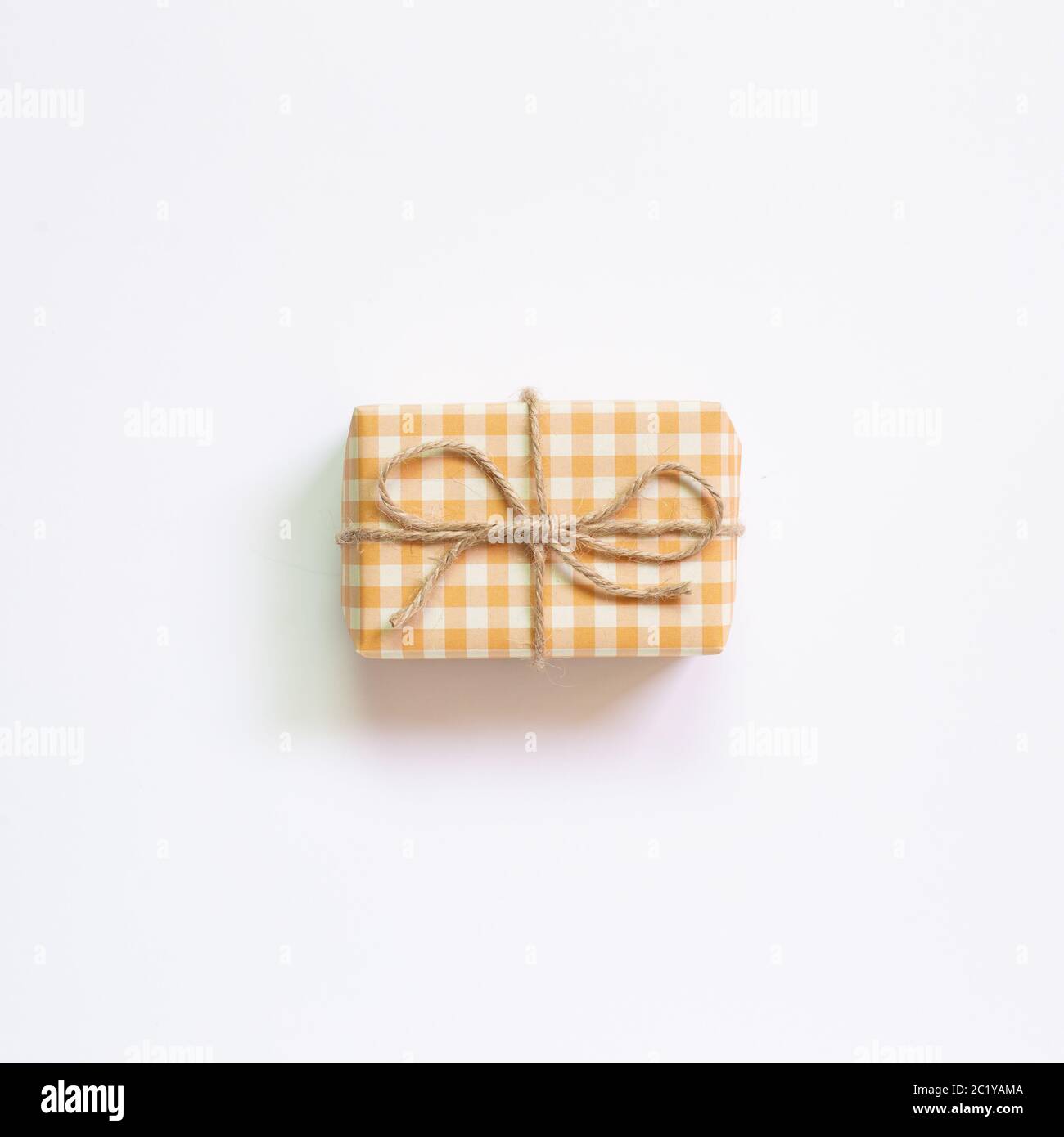 Yellow check pattern gift box isolated on white background. top view, copy space Stock Photo