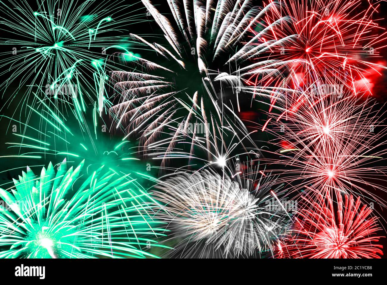 Green white and red fireworks background Stock Photo