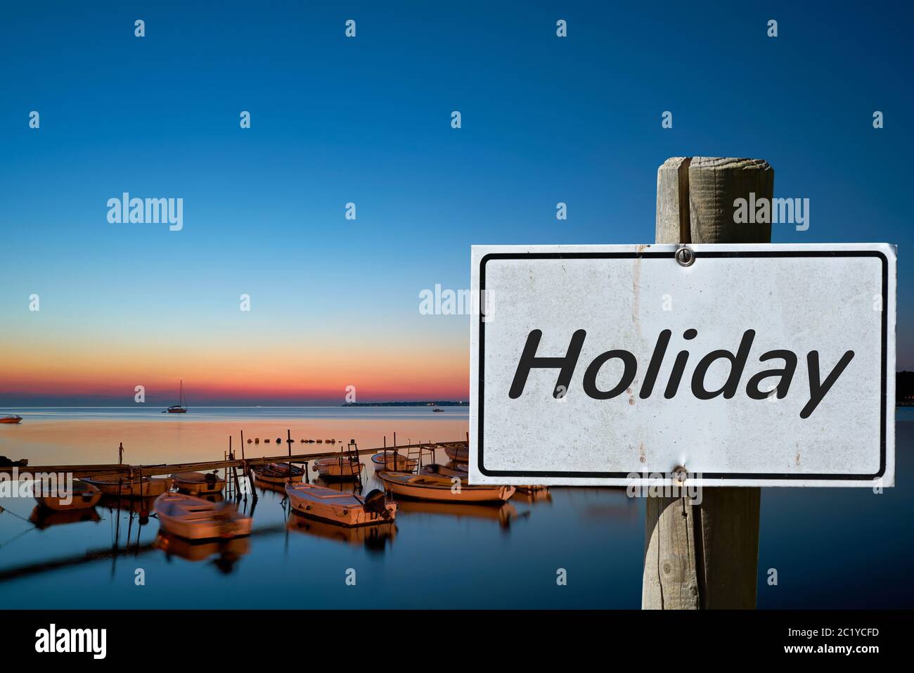 Sign on the shore of the Adriatic Sea near Porec with the inscription Holiday Stock Photo