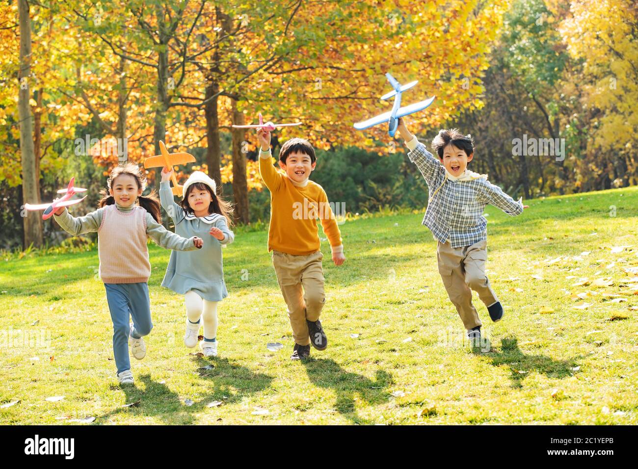 Happy children playing in the park with a toy plane Stock Photo - Alamy