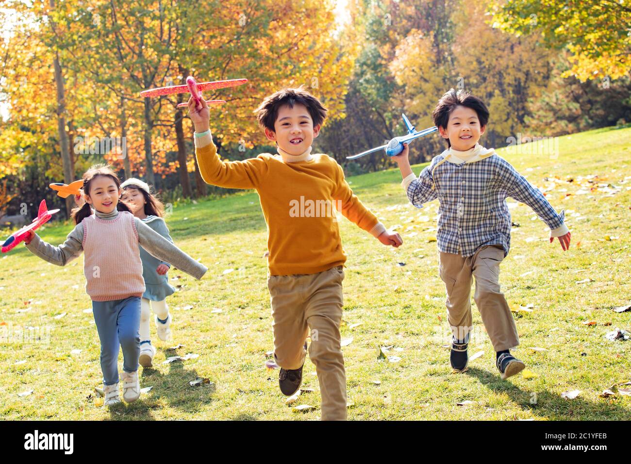 Happy children playing in the park with a toy plane Stock Photo - Alamy
