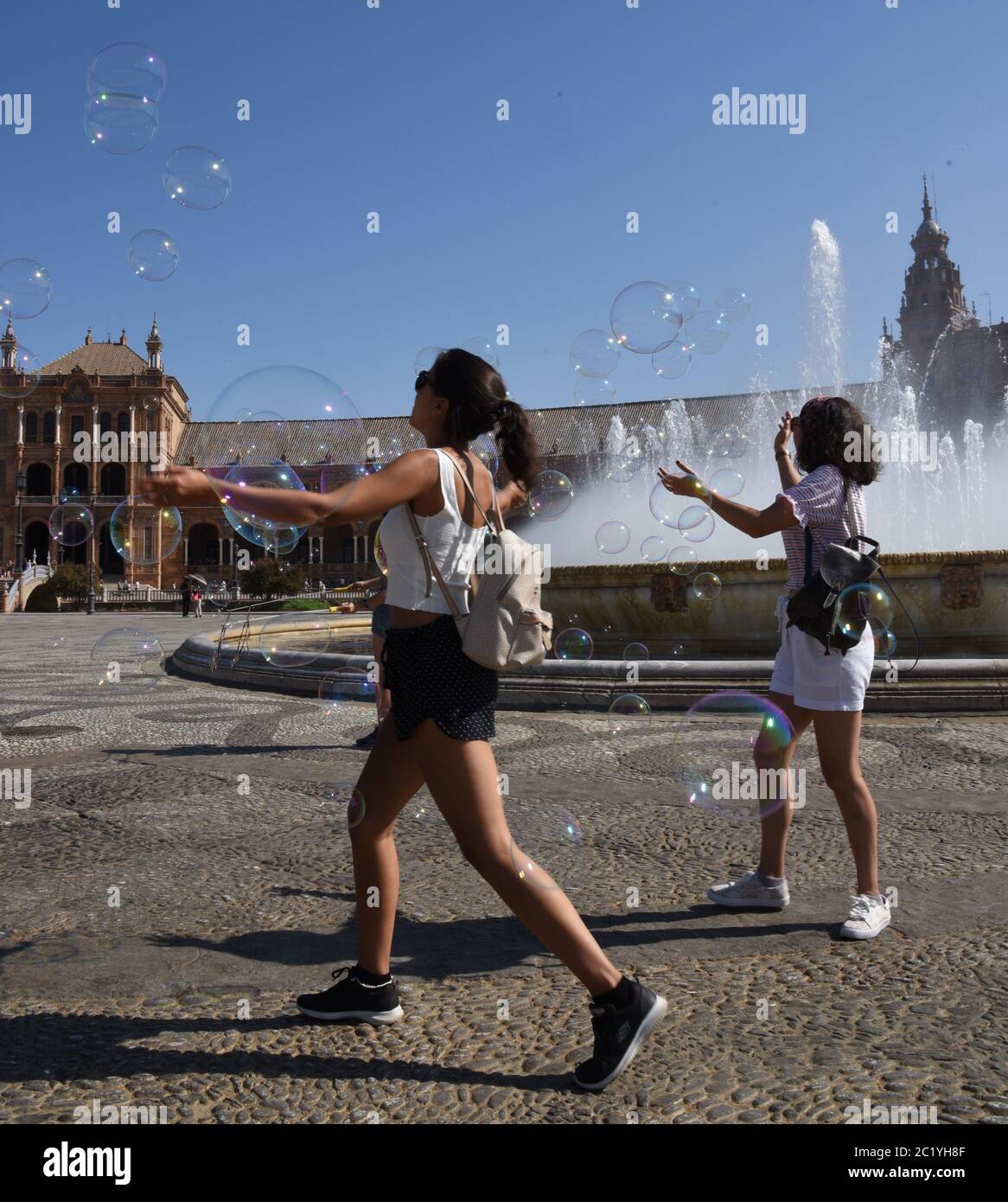 Catching Bubbles in Plaza España, Seville Stock Photo