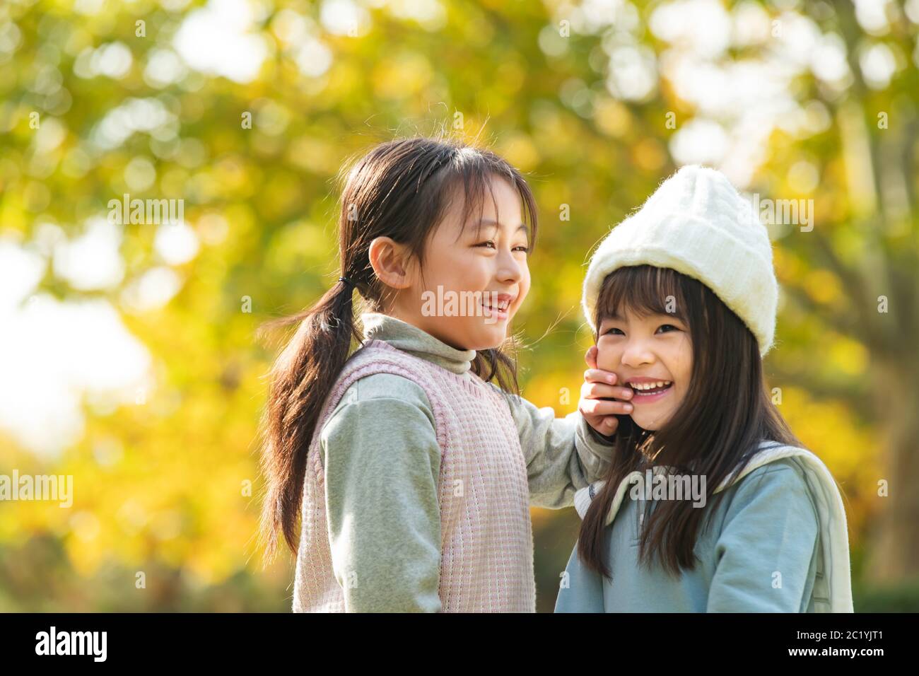 Two little girls playing in the park Stock Photo - Alamy