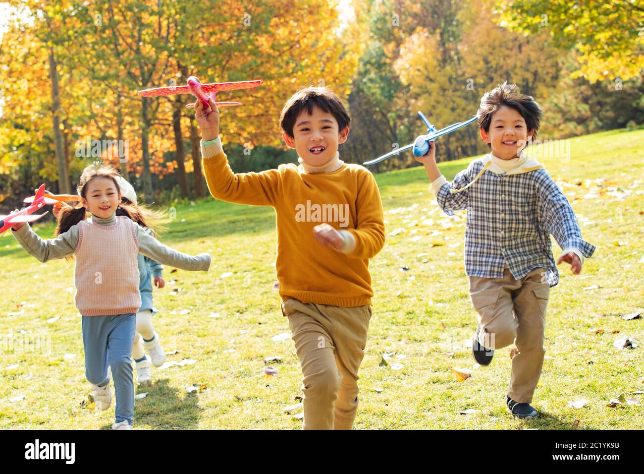 Happy children playing in the park with a toy plane Stock Photo - Alamy