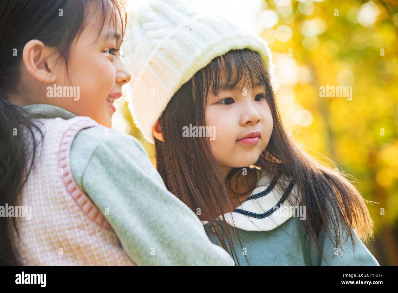 Two little girls playing in the park Stock Photo - Alamy
