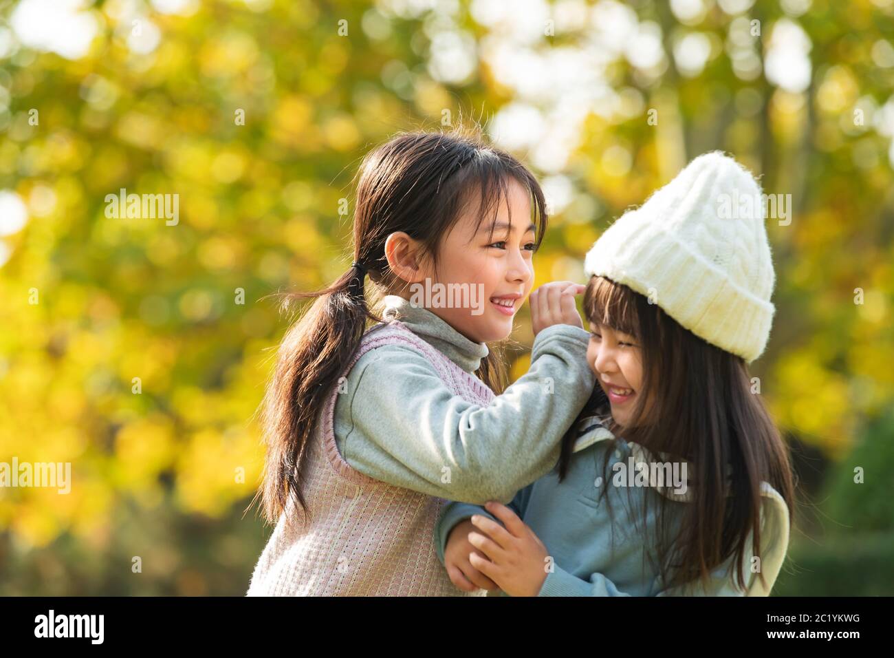 Two happy little girl playing in the park Stock Photo - Alamy