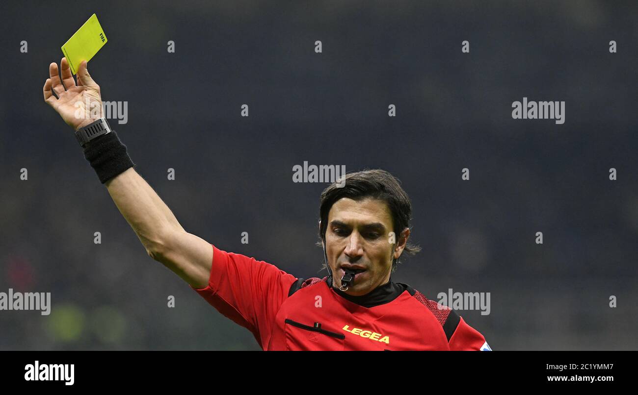 soccer referre holding a yellow card, at the san siro soccer stadium at night, in Milan. Stock Photo