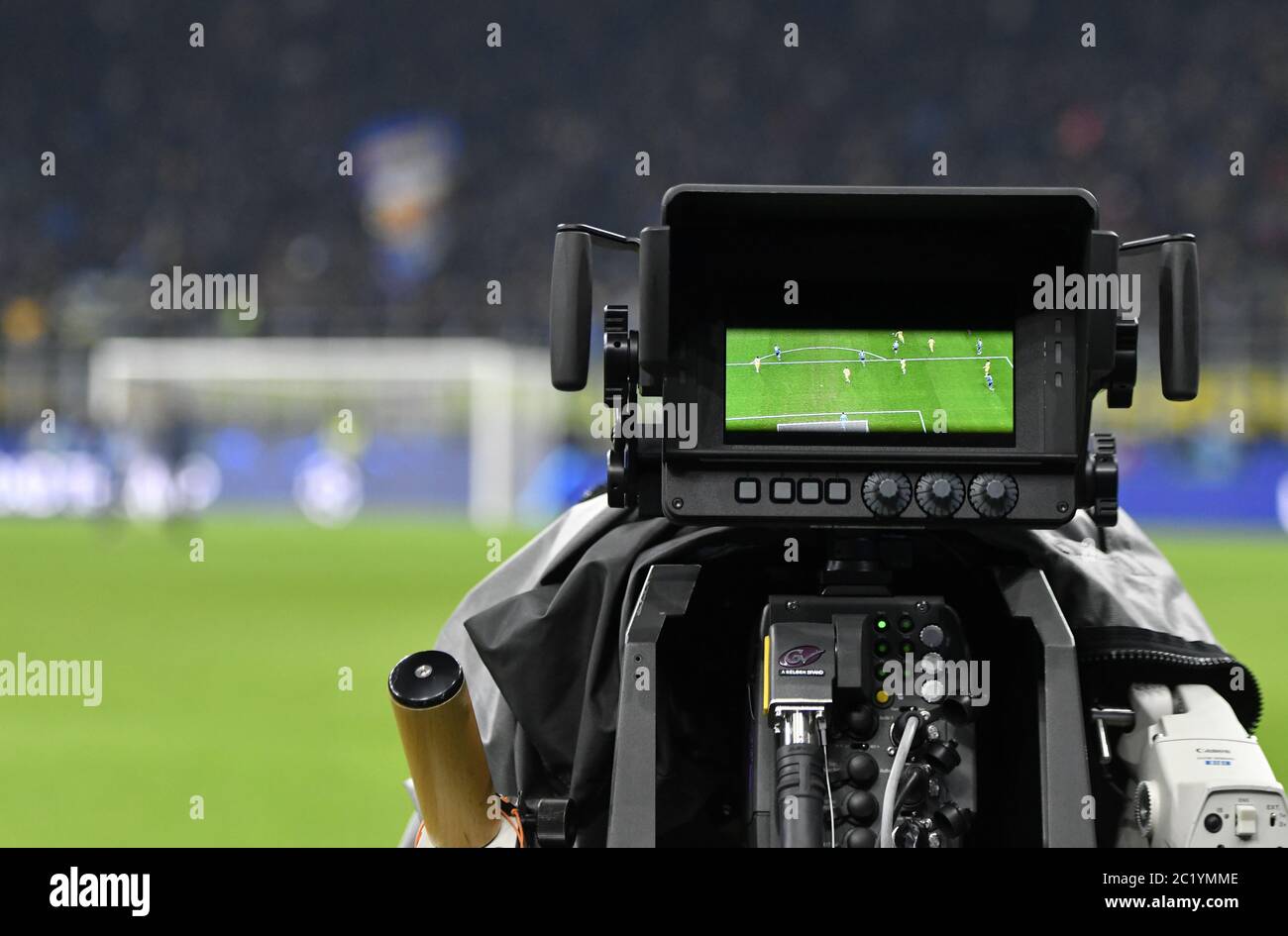 TV camera man shooting live a professional soccer match, at the san siro football stadium, in Milan Stock Photo