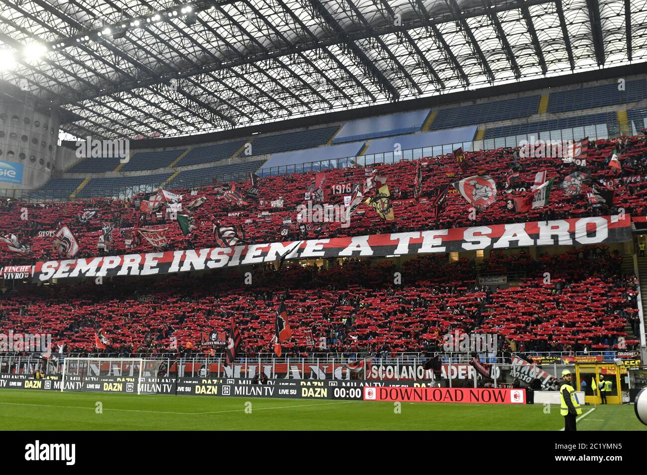 AC Milan soccer fans waving flags during the soccer match AC Milan vs FC Internazionale, in Milan. Stock Photo