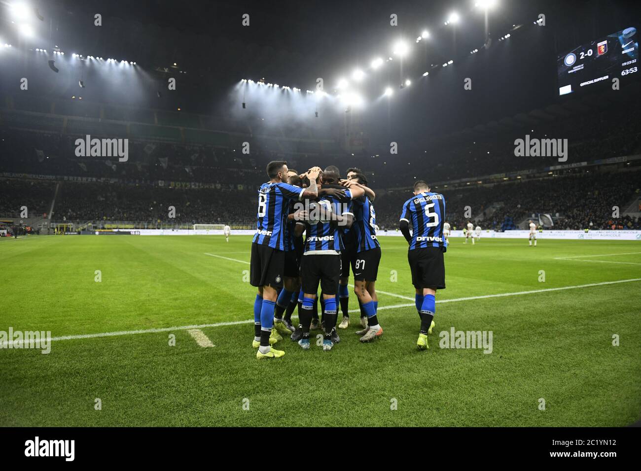 Inter Milan soccer team palyers embrace to celebrate the win, at the san siro soccer stadium at night, in Milan. Stock Photo