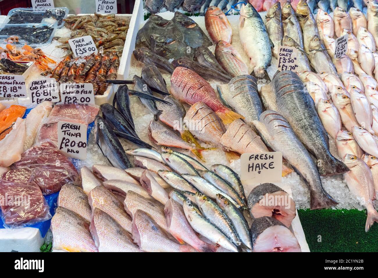 Different kinds of fish and prawns for sale at a market in Brixton, London Stock Photo
