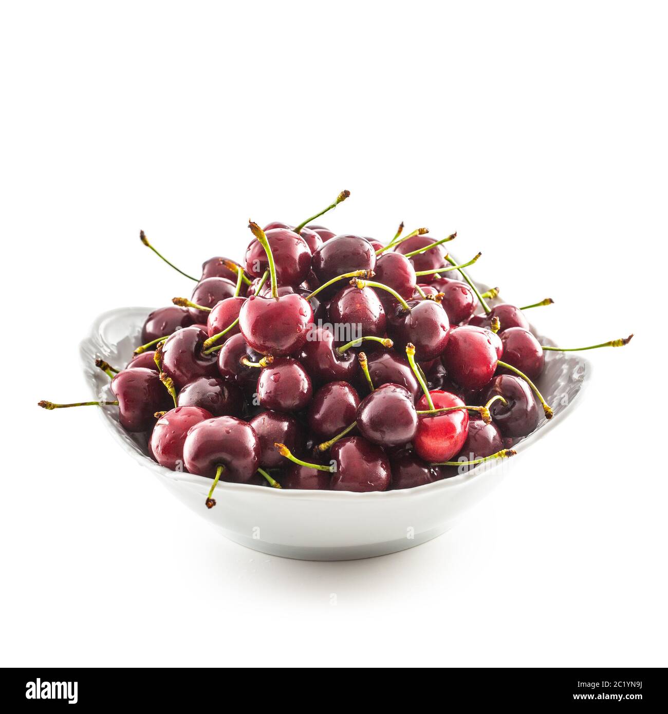 Sweet ripe cherries in bowl isolated on white background Stock Photo