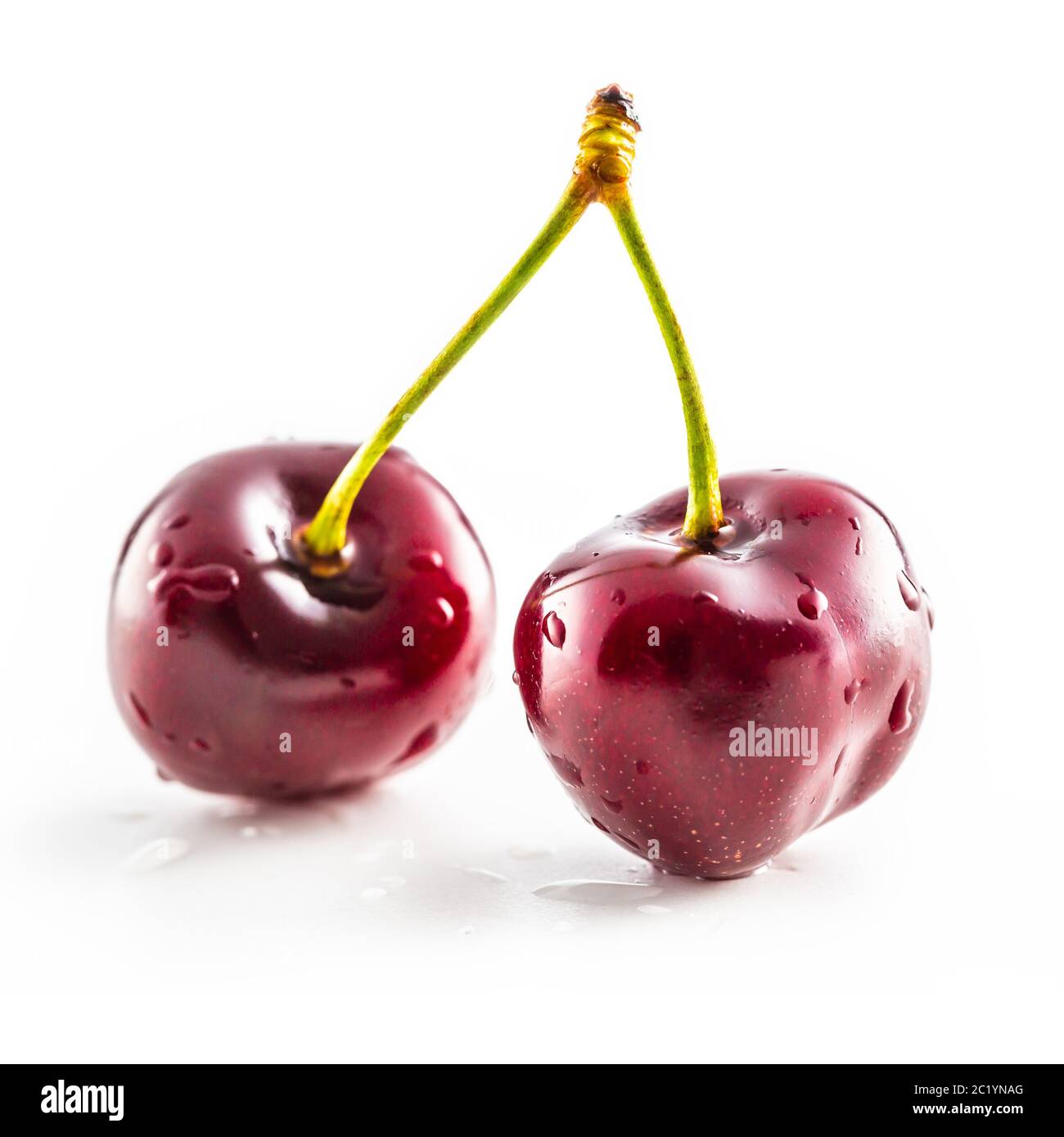 Sweet two ripe cherries isolated on white background Stock Photo