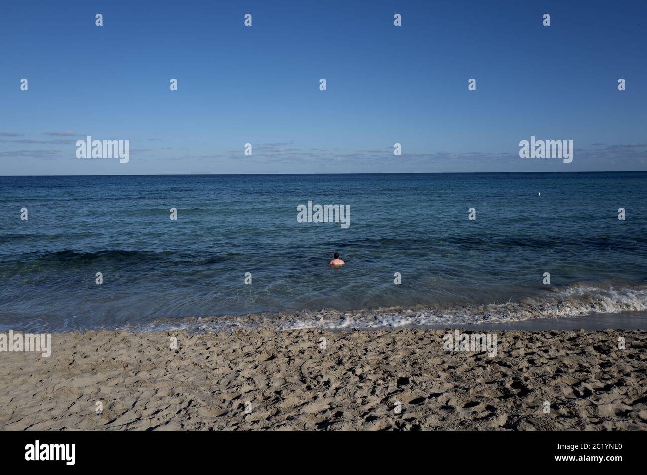 Solitary man bathing on the fisrt day of the year, on a sunny winter day, in Palermo. Stock Photo