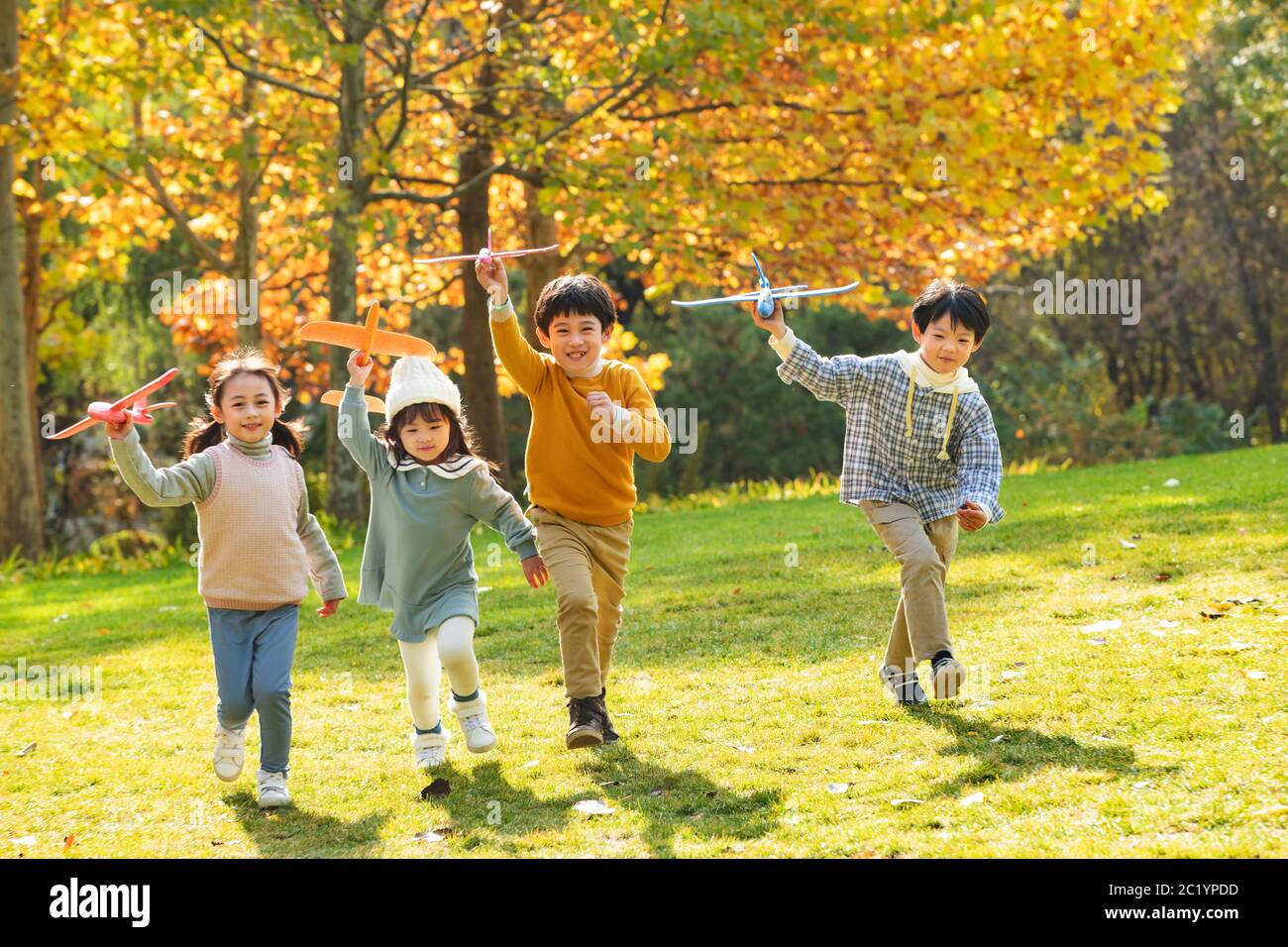 Happy children playing in the park with a toy plane Stock Photo - Alamy
