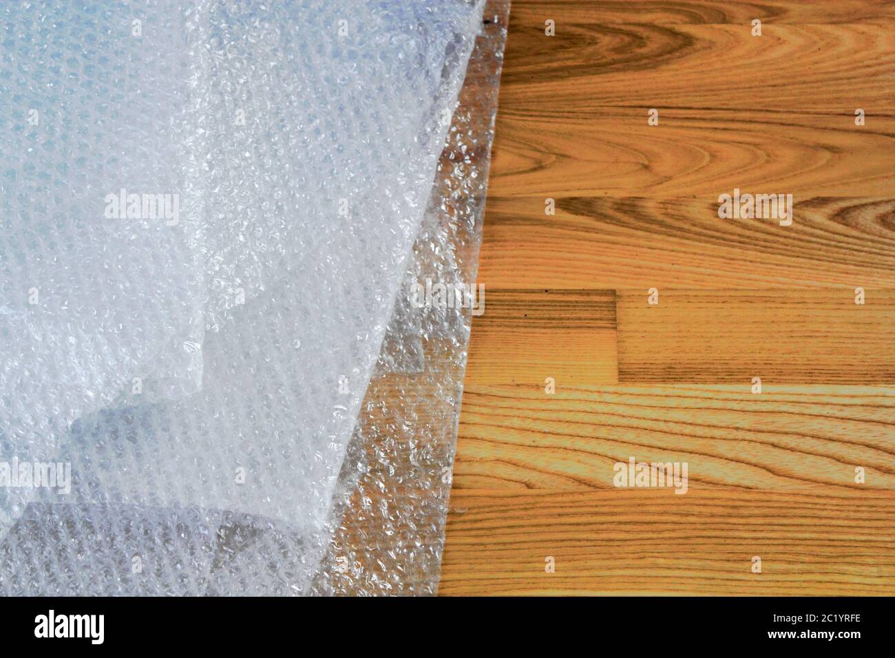 Bubble wrap on wooden floor Stock Photo