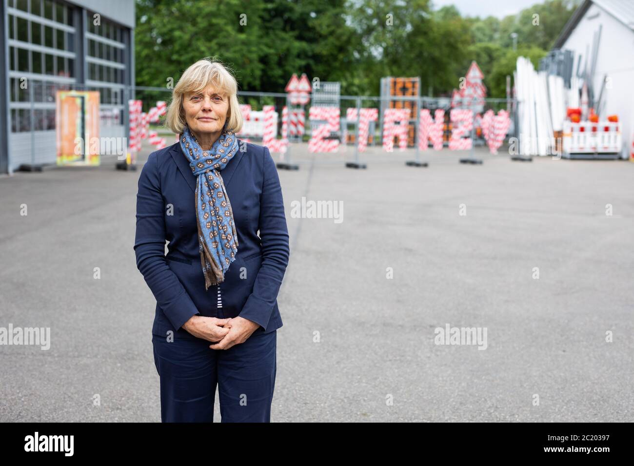 16 June 2020, Baden-Wuerttemberg, Radolfzell: Prof. Dr. Paula Lutum-Lenger, Director of the House of History in Stuttgart, is standing in the courtyard of the road maintenance department in Constance in front of the fence that separated Constance and Kreuzlingen during the Corona pandemic. For several weeks, the temporary border fence separated the neighbouring cities of Constance and Kreuzlingen in Switzerland. Now parts of it are to be moved to the Haus der Geschichte Baden-Württemberg. Photo: Philipp von Ditfurth/dpa Stock Photo
