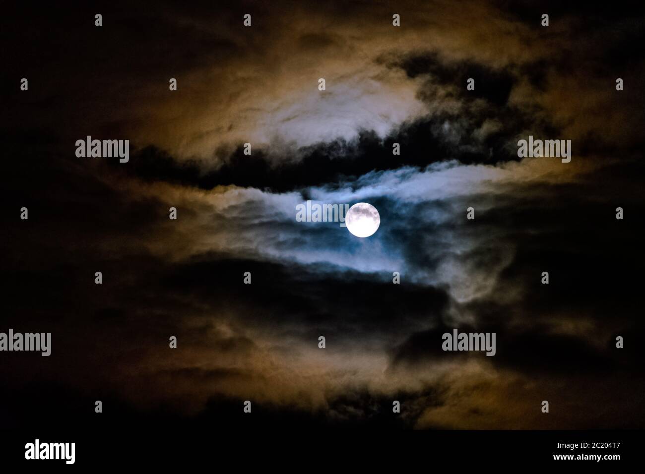 Dramatic night sky with full moon over United Kingdom Stock Photo