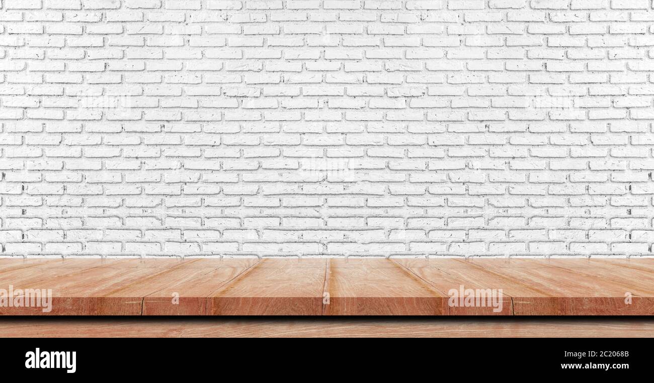 Empty wooden table top, counter or shelf on white brick wall background, For food display banner, backdrop. Stock Photo