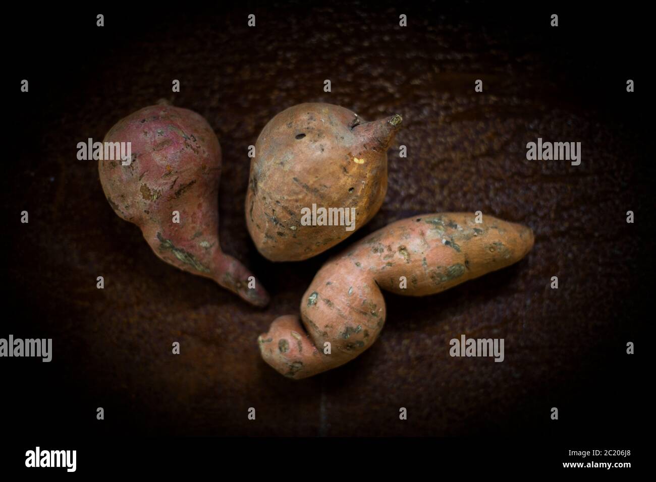 raw sweet potatoes on a wooden table, topview Stock Photo
