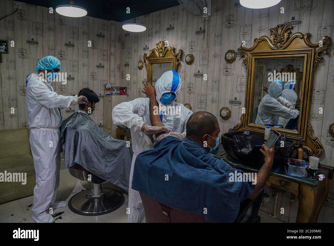 Dhaka, Dhaka, Bangladesh. 16th June, 2020. Barbers wearing protective
