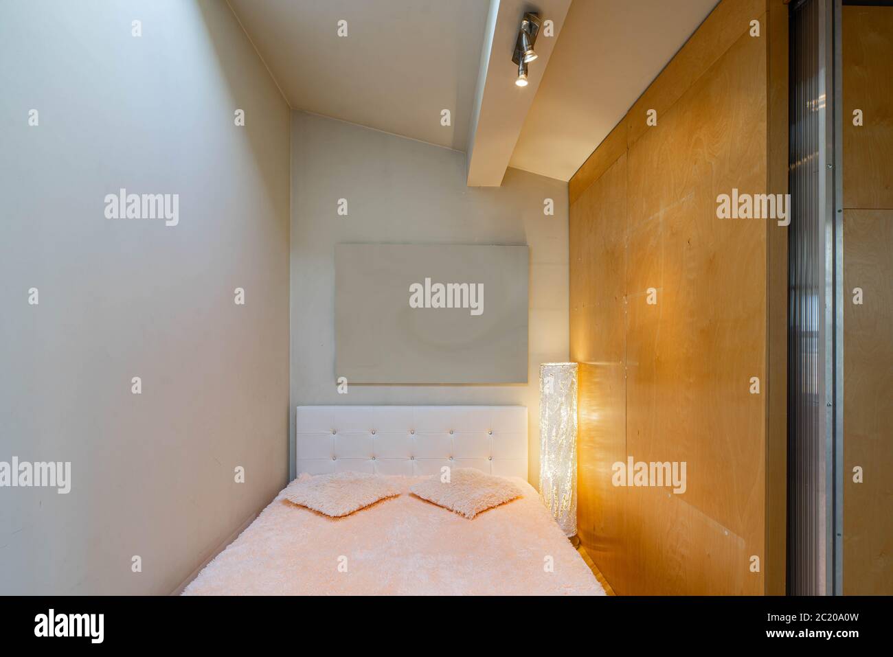 Small bed behind wooden sliding doors. Place for sleeping. Blurred