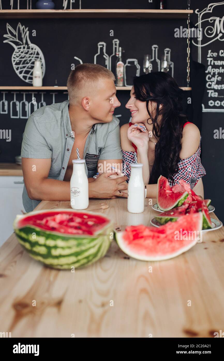 Beautiful pair looking at each other and smiling at kitchen Stock Photo