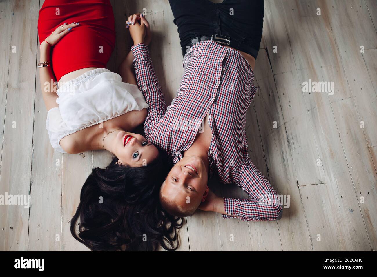 View from above of beautiful pair lying on floor Stock Photo