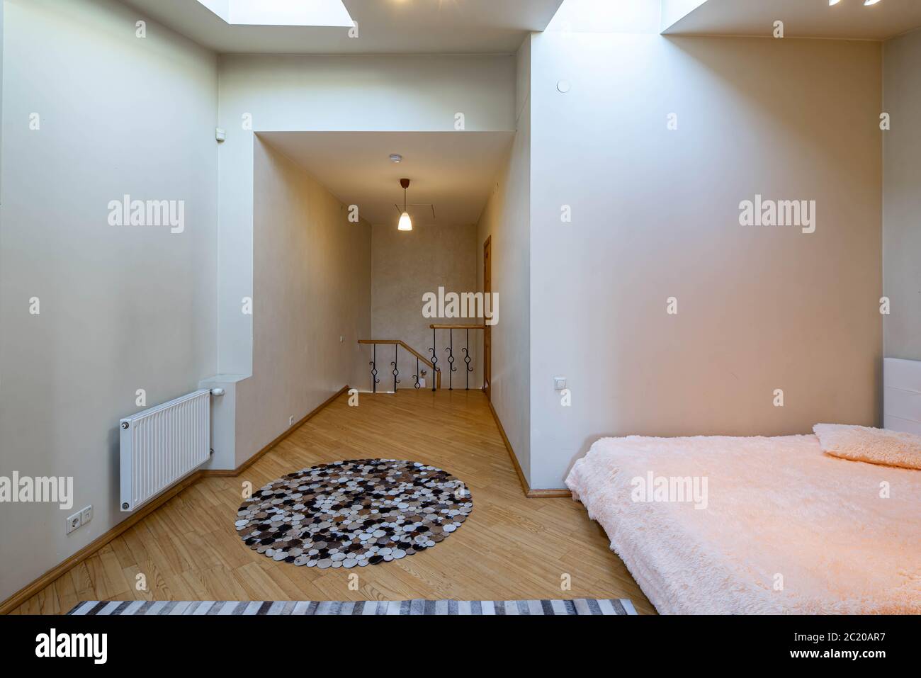 Modern interior of bedroom upstairs in luxury apartment. View of hall