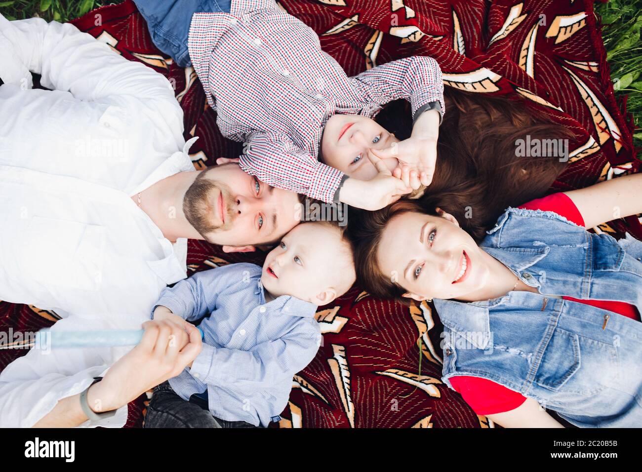 Happy family relaxing in nature hi-res stock photography and images - Alamy