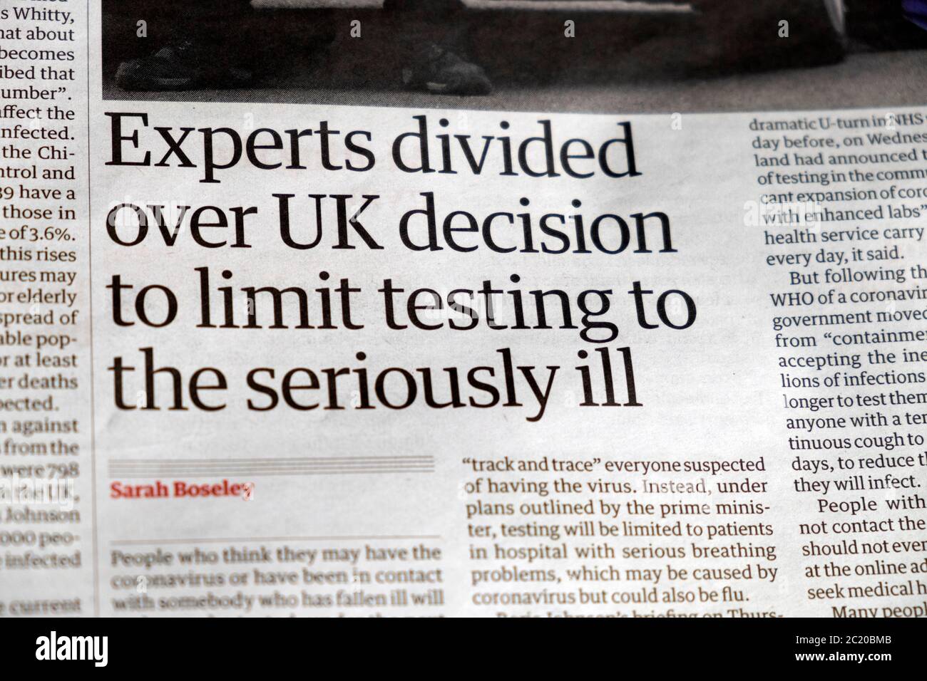 'Experts divided over UK decision to limit testing to the seriously ill'. Guardian newspaper test and trace headline London England UK Great Britain Stock Photo