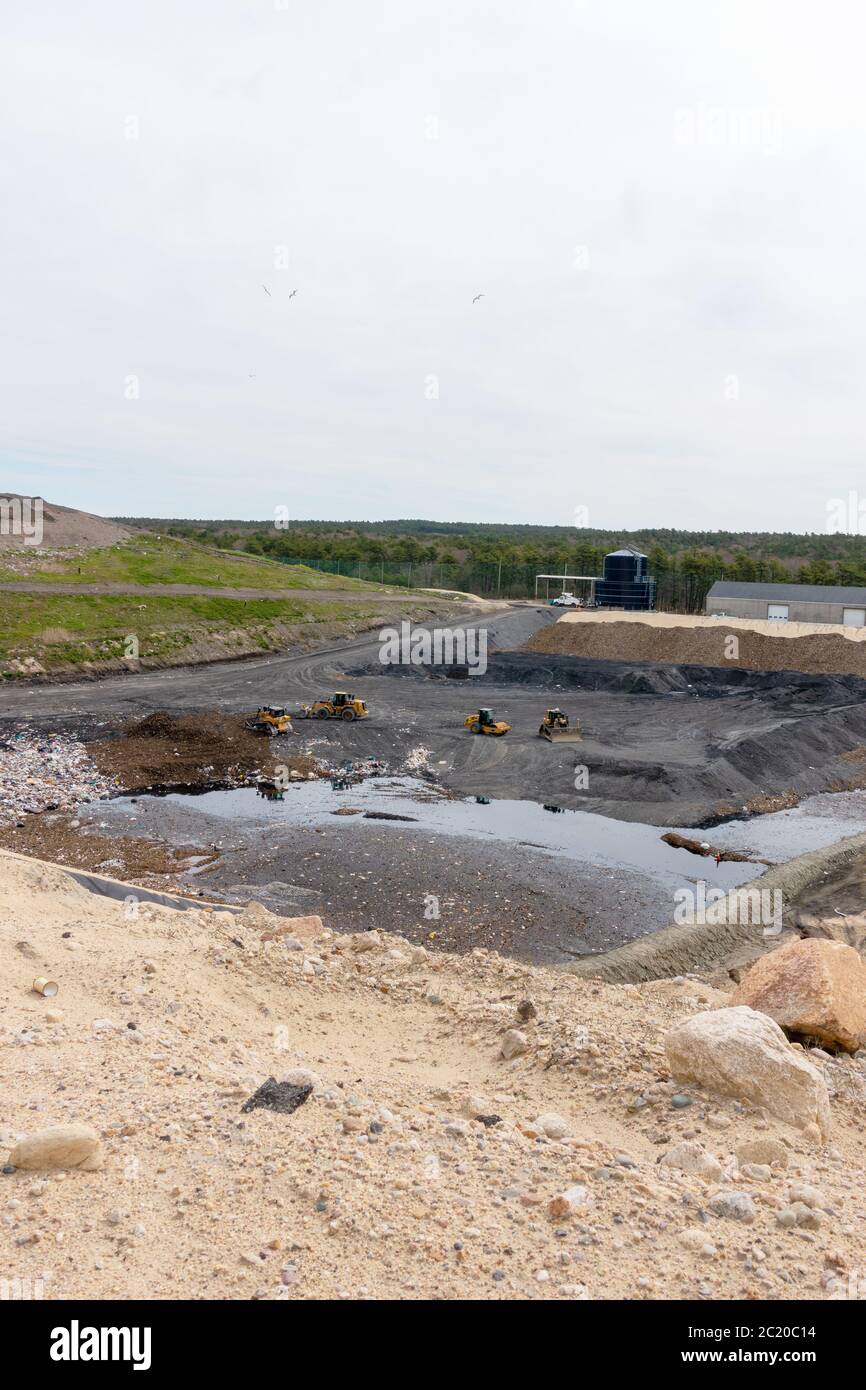 Landfill disposal cell site with heavy equipment at the Integrated Solid Waste Management Facility in Bourne, Cape Cod, Massachusetts USA Stock Photo