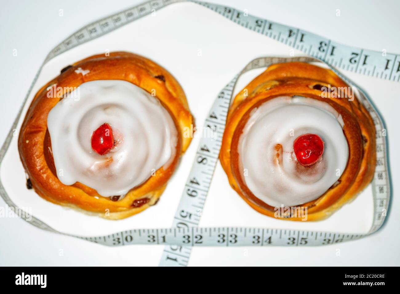 Belgian iced buns with tape measure Stock Photo