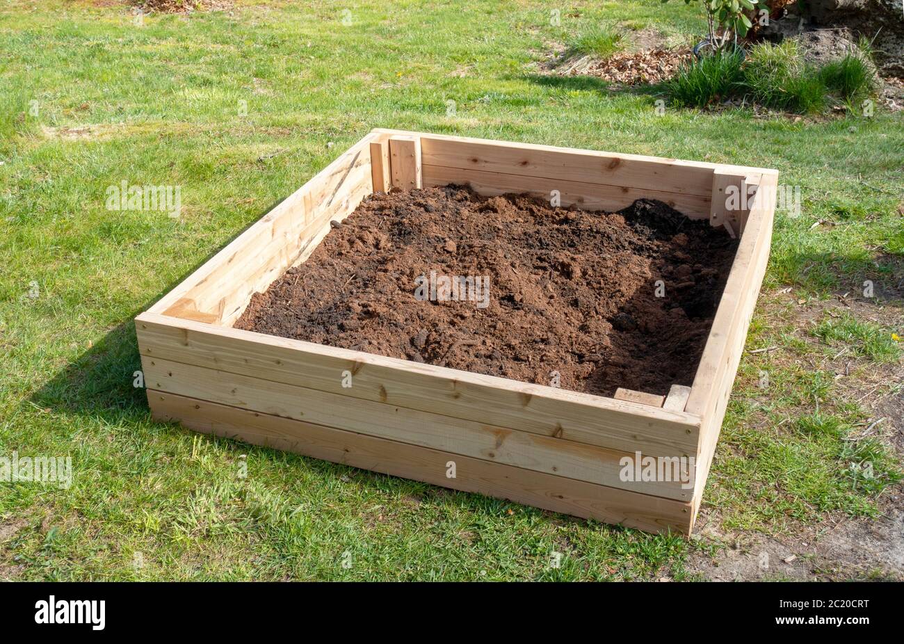 New cedar raised bed garden partially filled with compost built during