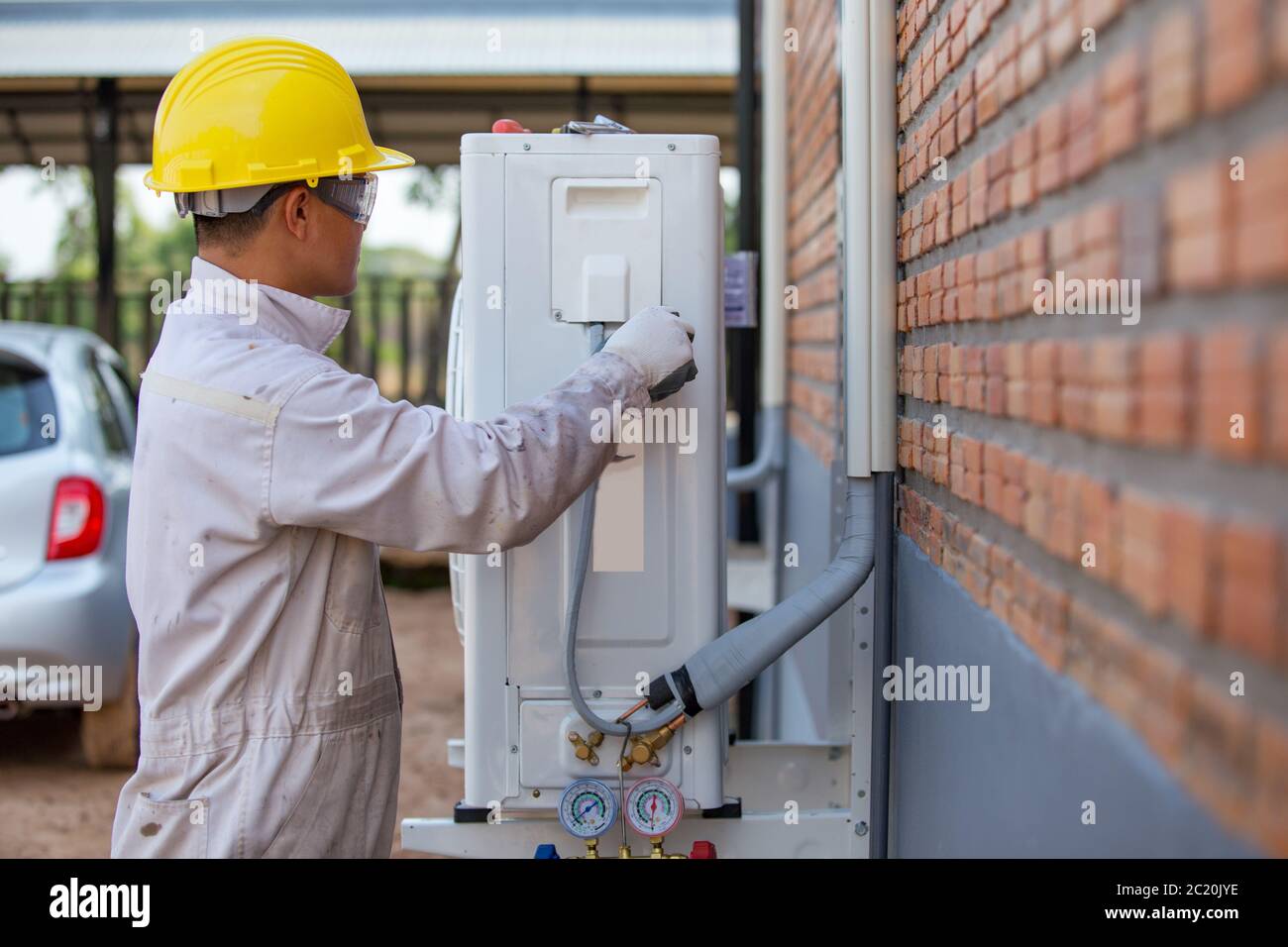The air conditioning technician is checking the air compressor Stock