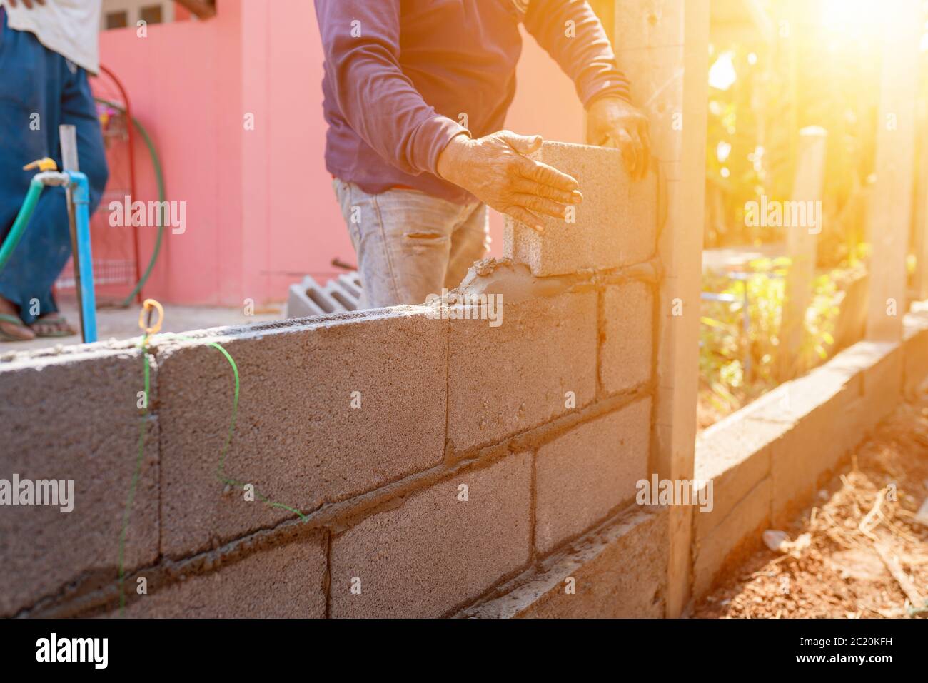 Masons constructing masonry to build fences Stock Photo