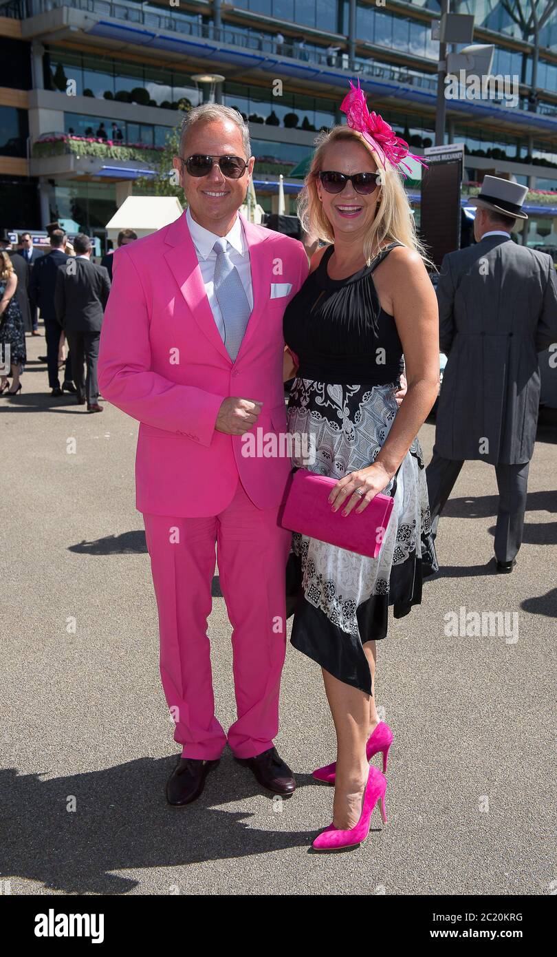 Ascot, Berkshire, UK. 22nd June, 2018. A man wears a vibrant pink suit and  his partner wears pink accessories with her dress at Royal Ascot. Credit:  Maureen McLean/Alamy Stock Photo - Alamy