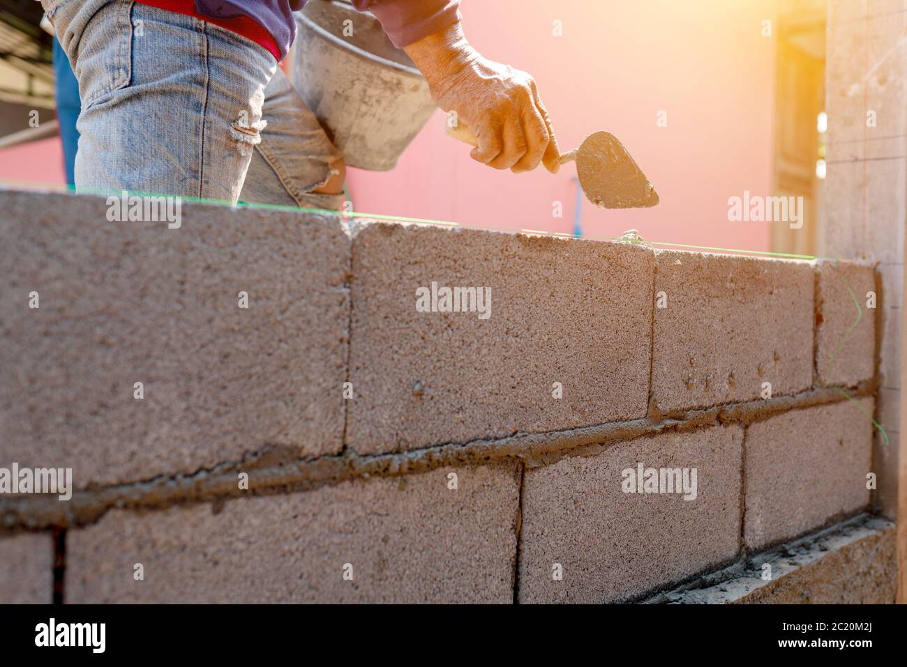 Bricklayer working on the construction of the wall or walls of the ...