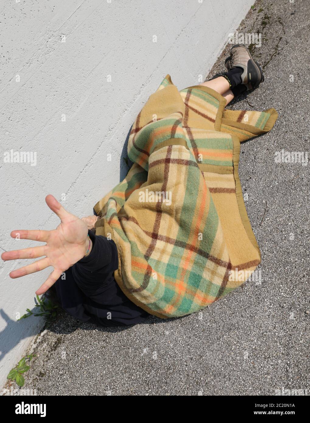 hand of the homeless while sleeping on the street under the dirty