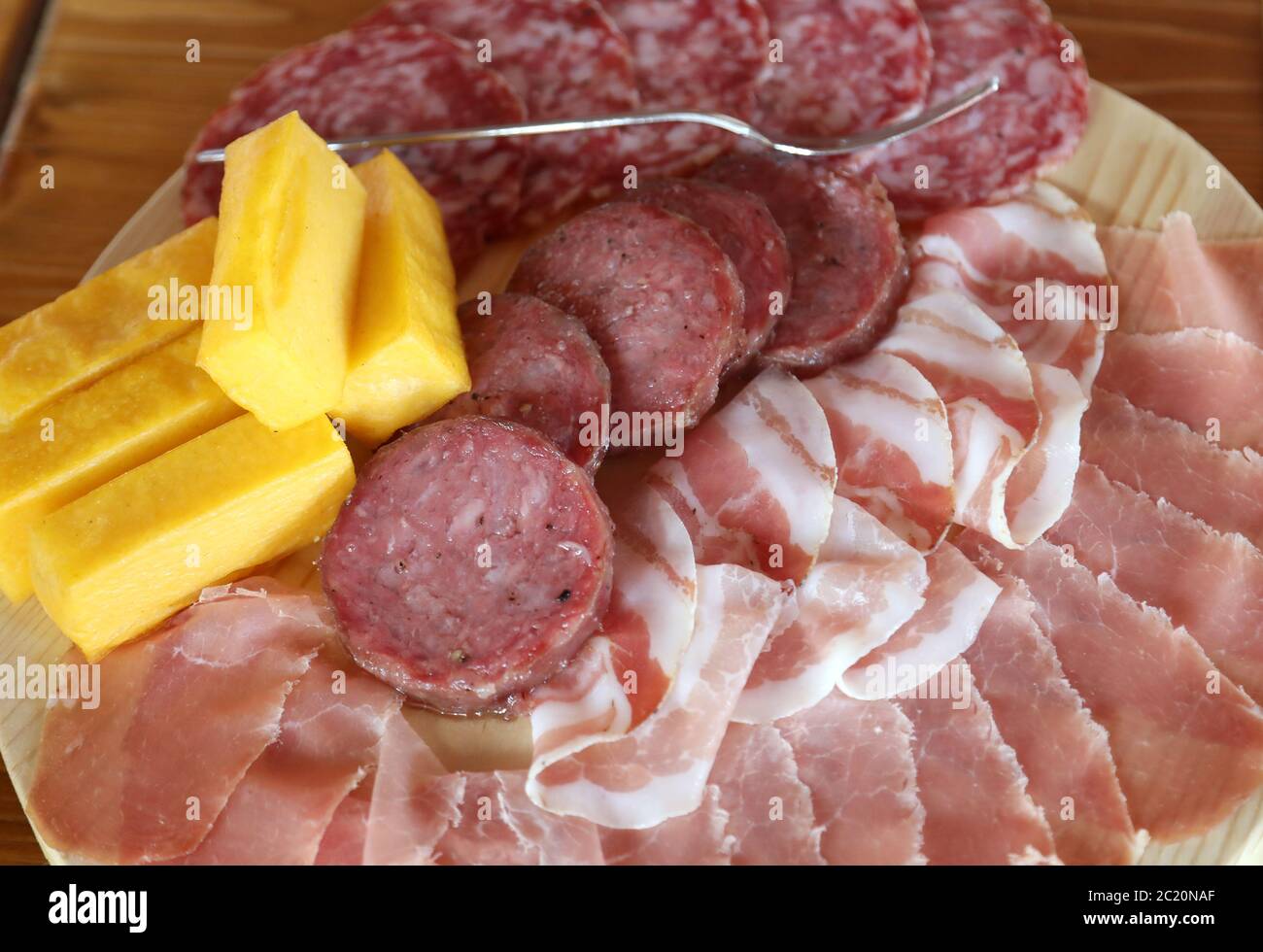 mixed cold cuts salami cooked and yellow polenta in the Italian farmhouse Stock Photo